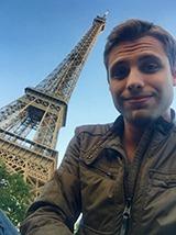 Ethan Brown in Paris next to the Eiffel Tower