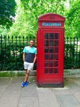 Zebb Ott next to a red phone booth in London